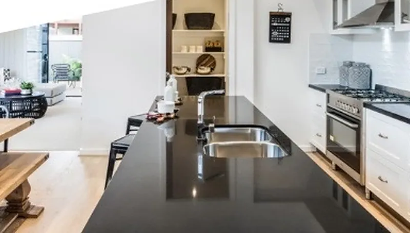 Bright kitchen with a dark stone island